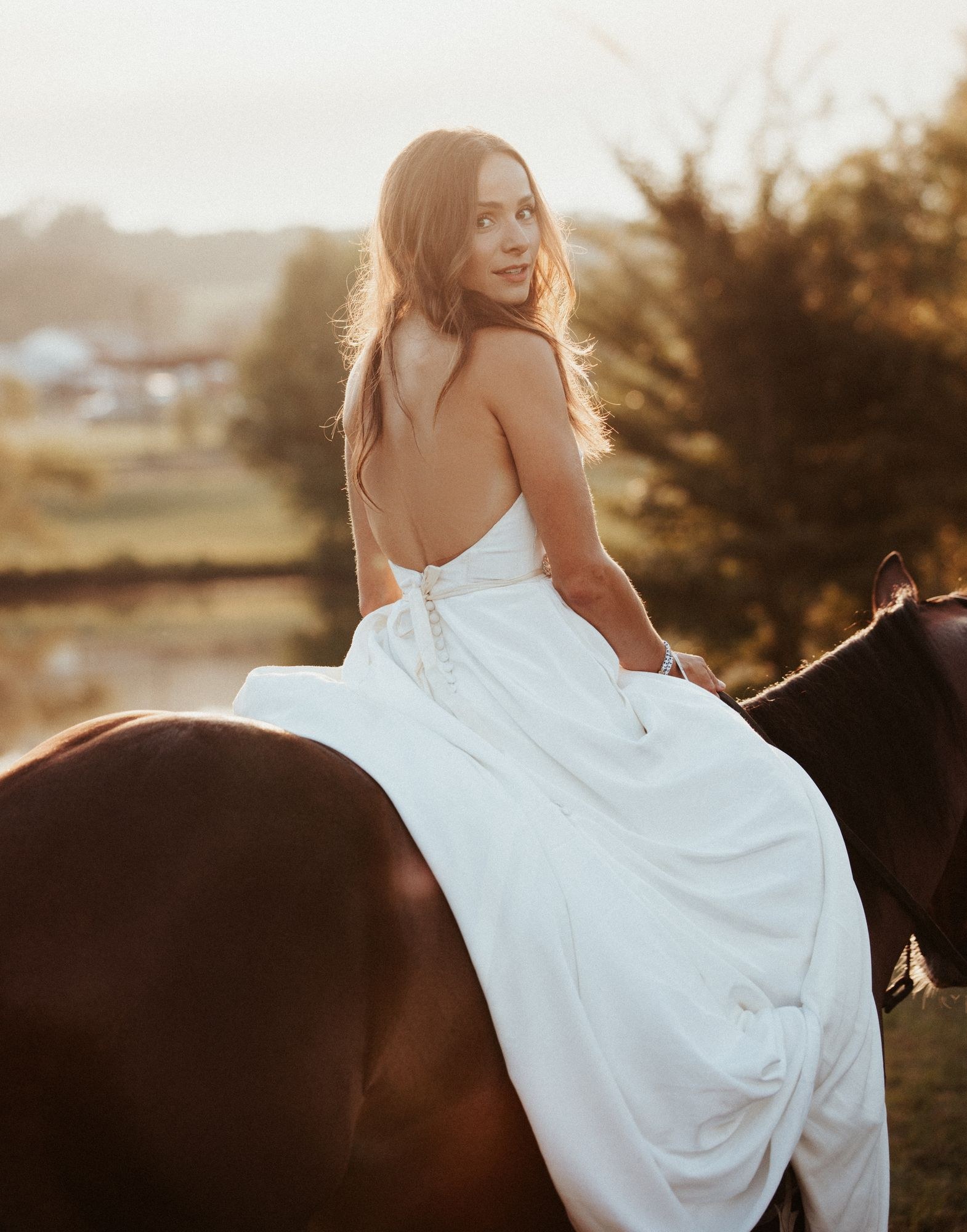 Bride seated on a horse in her gown