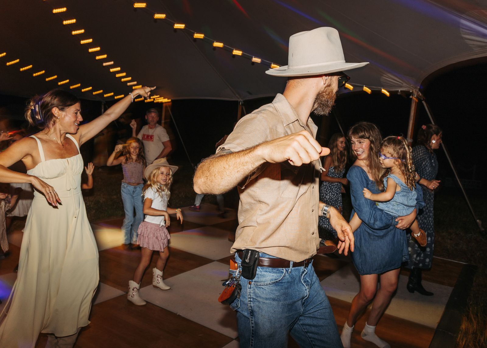 Guests dancing under string lights