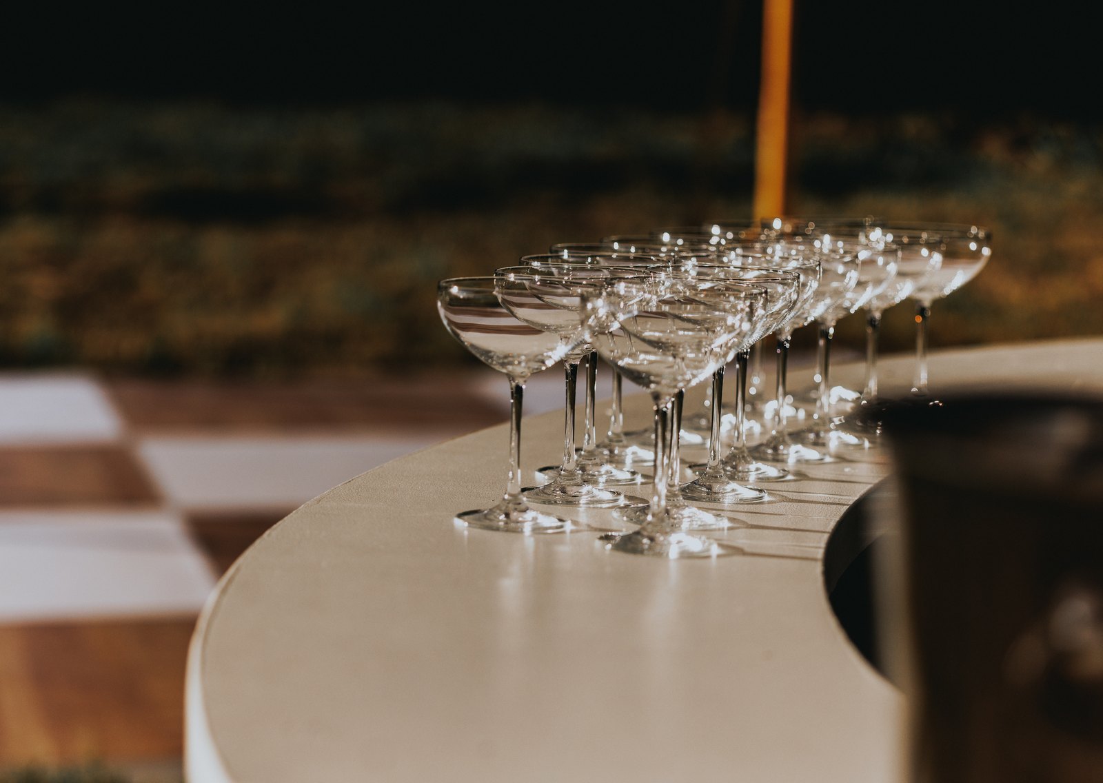Coupe glasses lined up on the bar