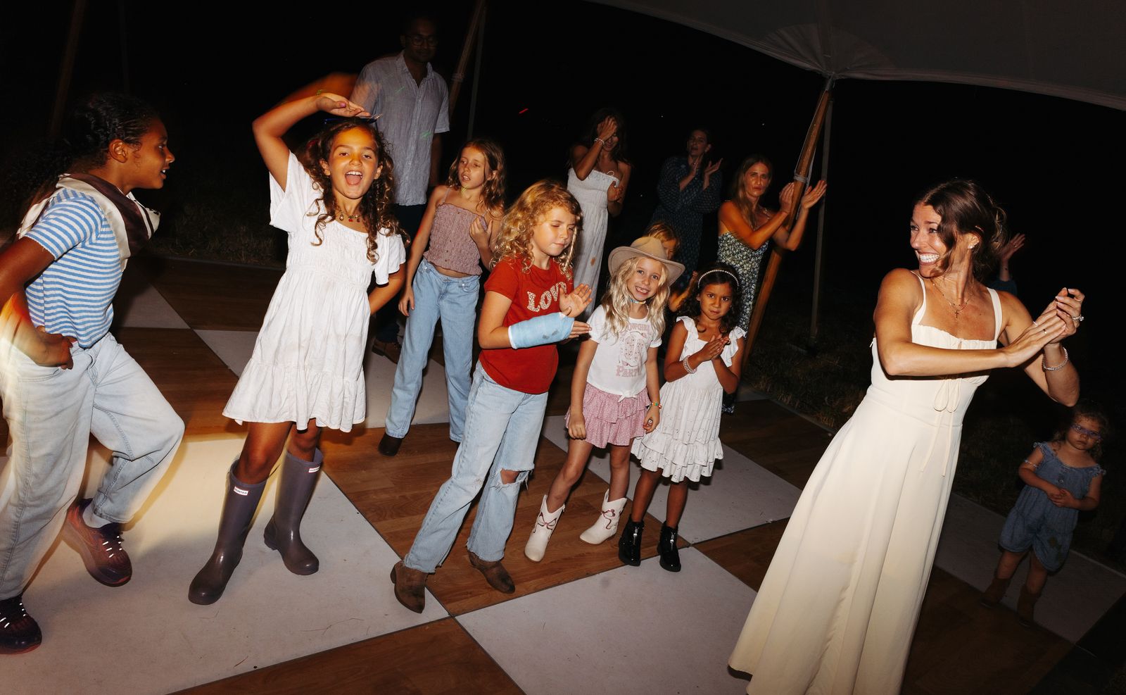 Kids dancing on the checkered dance floor