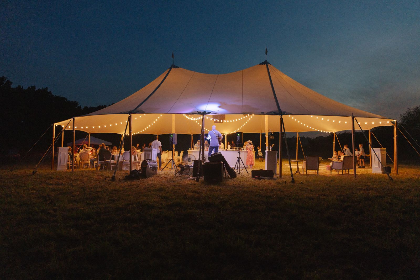 Tent glowing with string lights at dusk